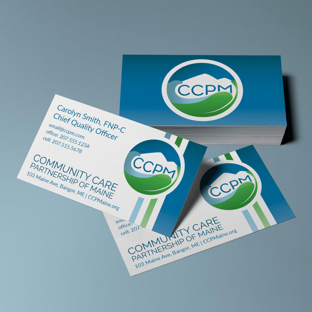 A short stack of business cards showing the CCPM logo and brand design